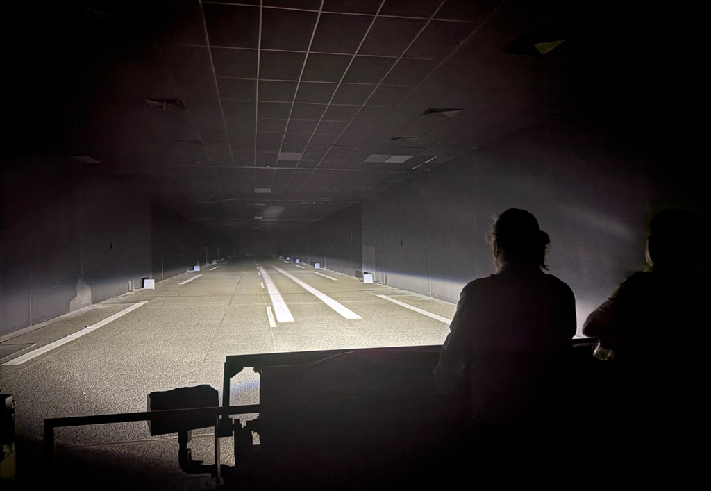 A long dark tunnel being illuminated by a hight.